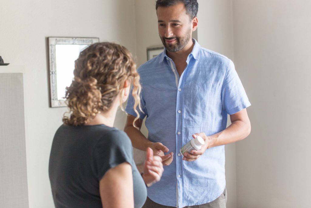 Male therapist consulting female patient going over nutritional product recommendation