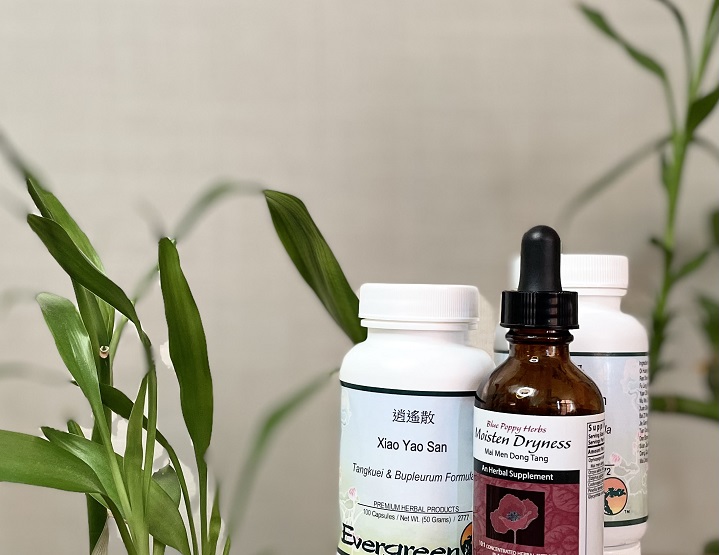 Healthy Qi herbal supplements and tincture featured in office with bamboo plants